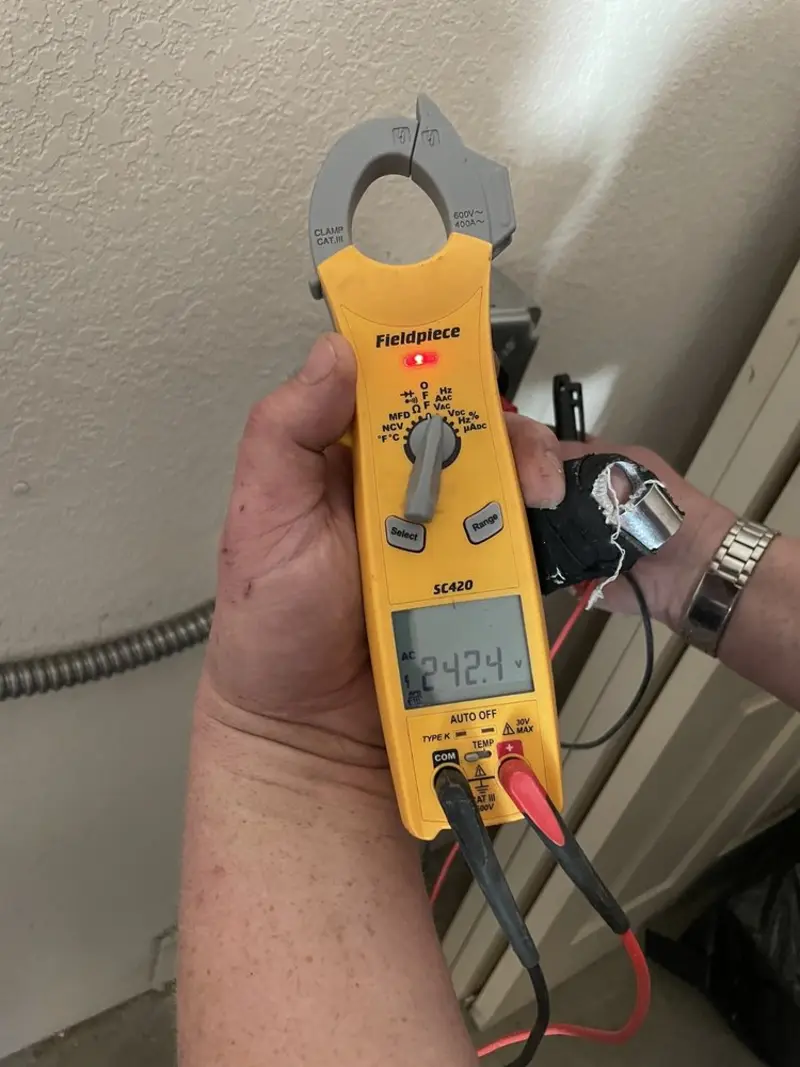 Voltage testing with clamp meter during Recessed Lighting Installation in Benton City